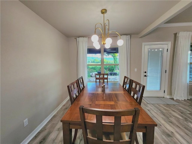 dining area featuring baseboards, light wood-style floors, and a notable chandelier