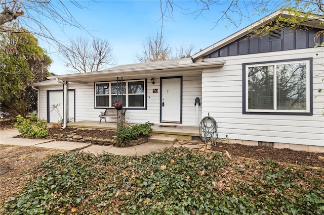 single story home featuring crawl space, a garage, and board and batten siding