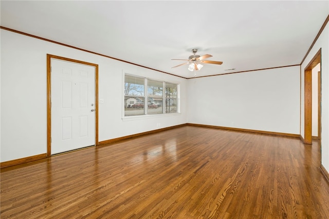 interior space with ornamental molding, ceiling fan, baseboards, and wood finished floors