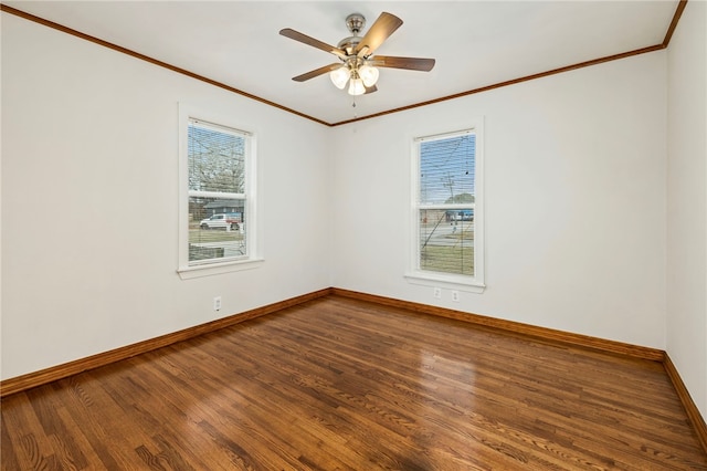 empty room featuring crown molding, ceiling fan, wood finished floors, and baseboards