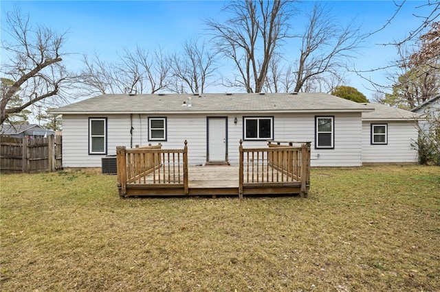 rear view of property with a yard, cooling unit, fence, and a wooden deck