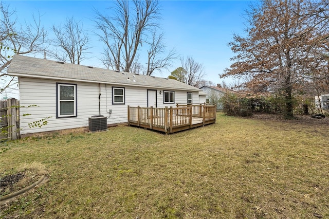 back of house with central AC unit, fence, a deck, and a yard