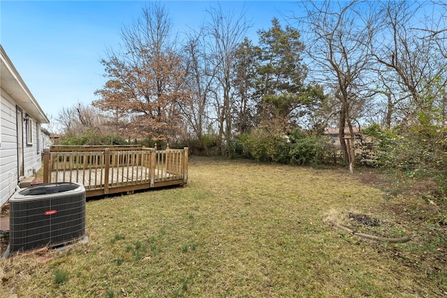 view of yard featuring central air condition unit and a deck