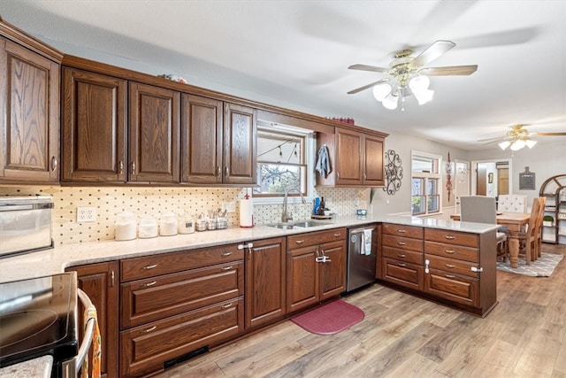 kitchen with electric range, light wood-style floors, a sink, dishwasher, and a peninsula