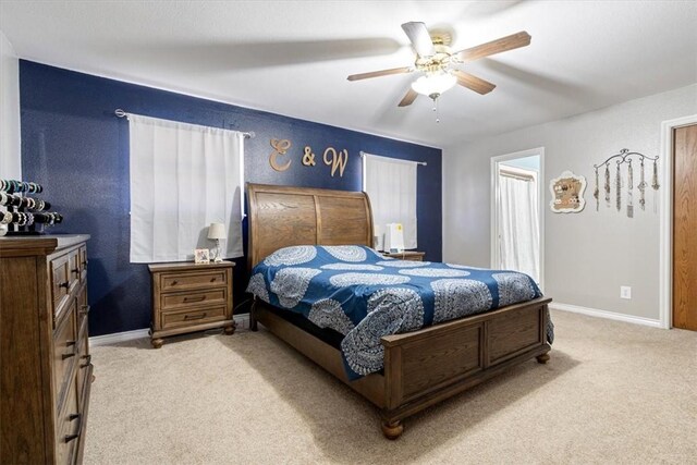 carpeted bedroom with a ceiling fan and baseboards