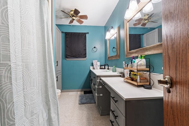 full bath featuring ceiling fan, vanity, and baseboards