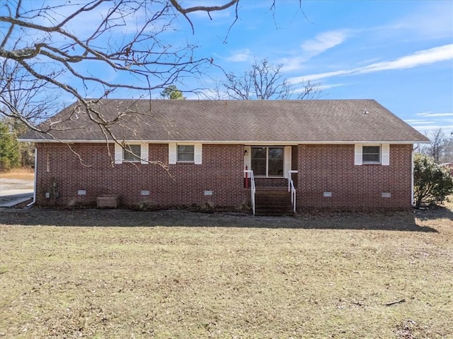 view of front of property with roof with shingles, brick siding, crawl space, and a front lawn