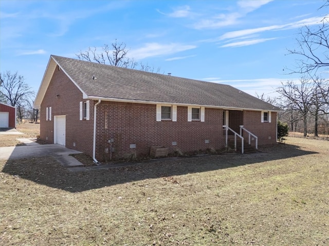 rear view of house featuring a garage, brick siding, driveway, roof with shingles, and crawl space