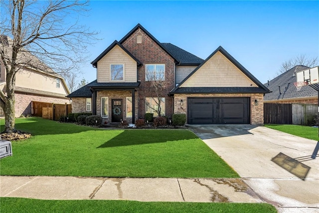 craftsman house with a garage, concrete driveway, a front yard, and fence