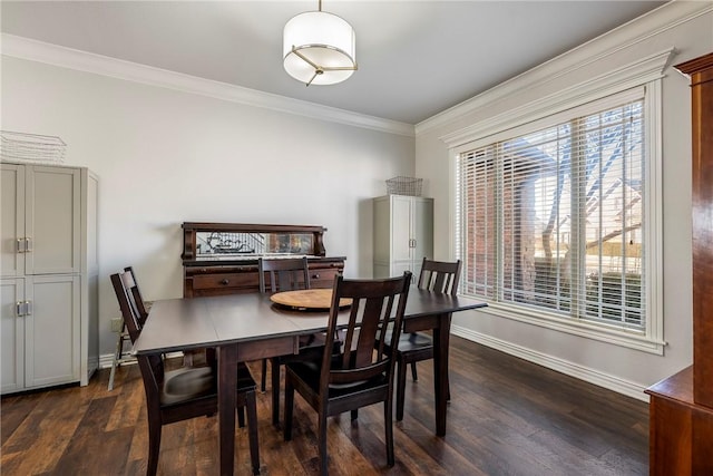 dining room featuring dark wood-style floors, baseboards, ornamental molding, and a wealth of natural light