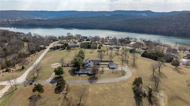 birds eye view of property featuring a water view and a view of trees