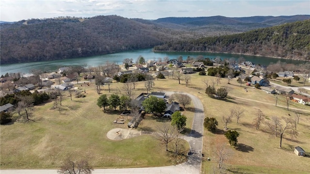 drone / aerial view featuring a water view and a view of trees