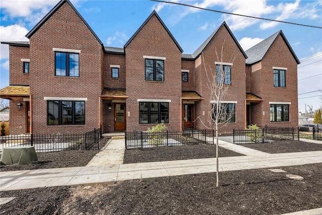 445 NW C St, Bentonville, AR 72712 - townhome / multi-family property featuring brick siding and a fenced front yard