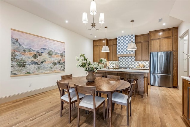 445 NW C St, Bentonville, AR 72712 - dining space featuring light wood-style floors, recessed lighting, and a chandelier