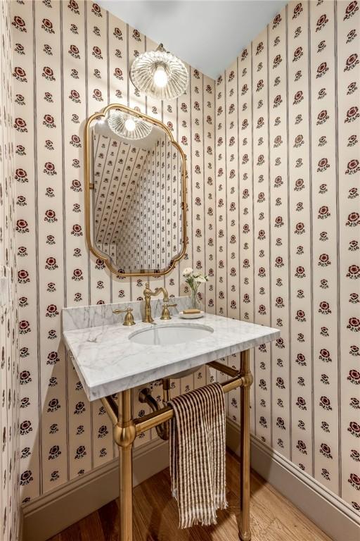 445 NW C St, Bentonville, AR 72712 - wine room featuring light wood finished floors and wallpapered walls