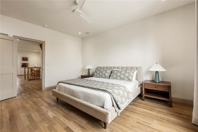 445 NW C St, Bentonville, AR 72712 - bedroom with light wood-type flooring and ceiling fan