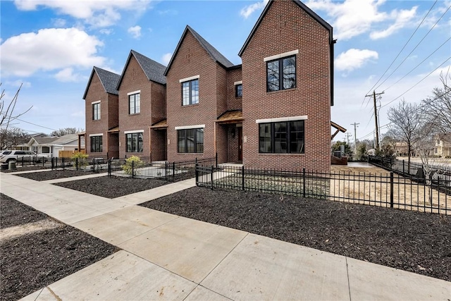 445 NW C St, Bentonville, AR 72712 - view of front of property with brick siding, a fenced front yard, and a residential view
