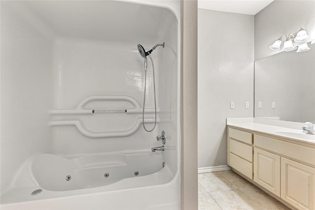 full bath with tile patterned flooring, a combined bath / shower with jetted tub, vanity, and baseboards