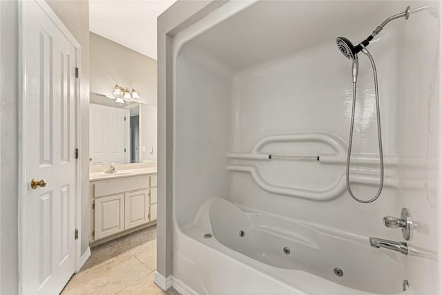 full bath with a combined bath / shower with jetted tub, vanity, and tile patterned floors