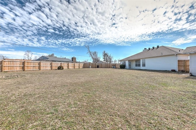 view of yard with a fenced backyard