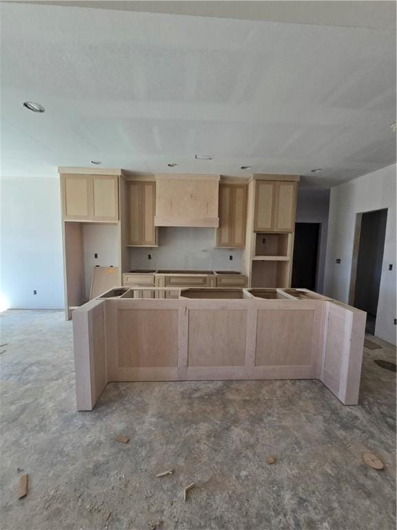 kitchen featuring a kitchen island and light brown cabinetry