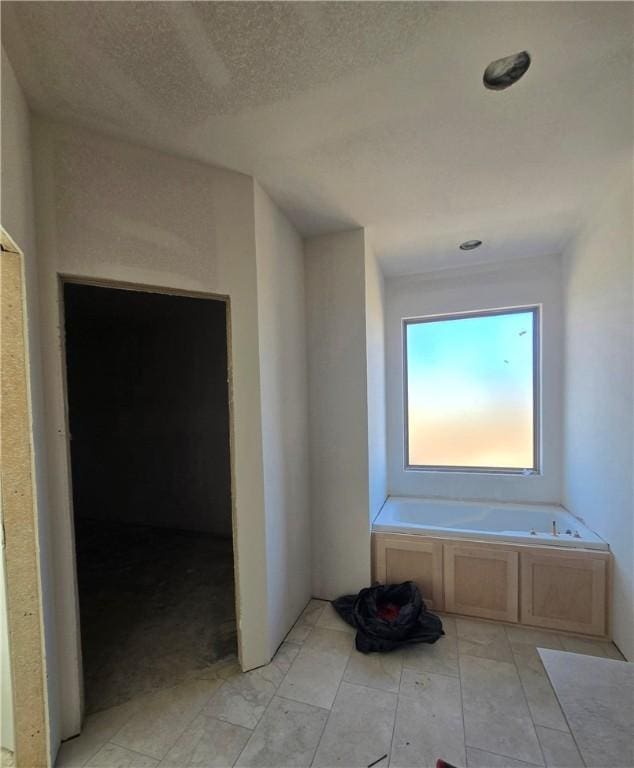 hallway with a textured ceiling