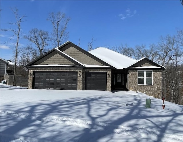 view of front of home with a garage and brick siding