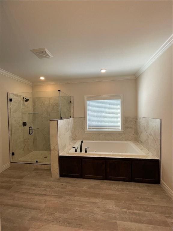 full bathroom with visible vents, ornamental molding, wood finished floors, a shower stall, and a bath