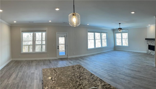 5 Burns Cir, Bella Vista, AR 72714 - unfurnished living room with ceiling fan, wood finished floors, baseboards, crown molding, and a stone fireplace