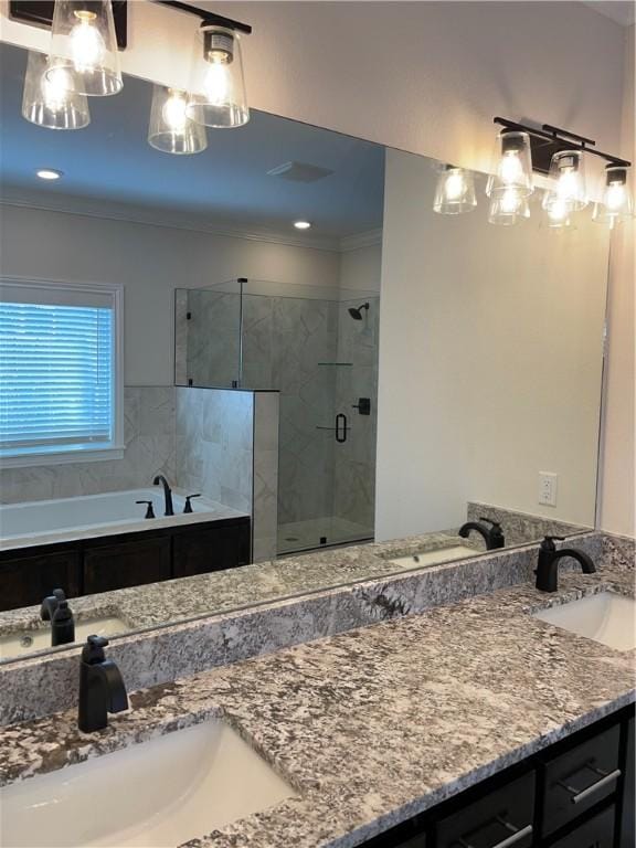 full bath with a stall shower, ornamental molding, and a sink