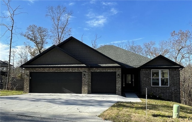 craftsman-style house with a shingled roof, concrete driveway, brick siding, and an attached garage