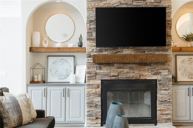 living room with a stone fireplace