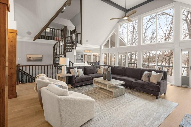 living room with plenty of natural light, a high ceiling, and wood finished floors