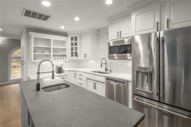 kitchen with white cabinetry, visible vents, appliances with stainless steel finishes, and a sink