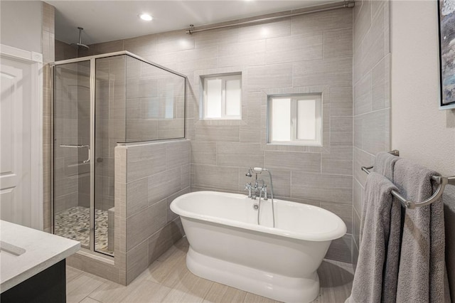 8354 Hopper Rd, Rogers, AR 72756 - full bath featuring a stall shower, a soaking tub, vanity, and tile walls