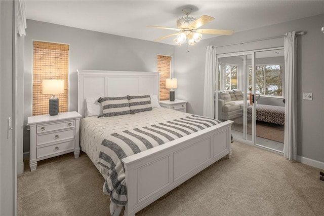 bedroom with light carpet, ceiling fan, baseboards, and a closet