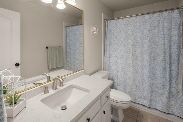 bathroom featuring toilet, tile patterned flooring, and vanity