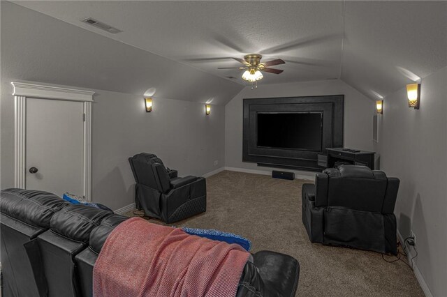 home theater featuring ceiling fan, visible vents, baseboards, lofted ceiling, and carpet