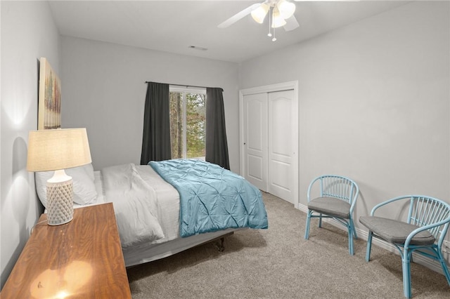 bedroom with a closet, a ceiling fan, carpet, and visible vents