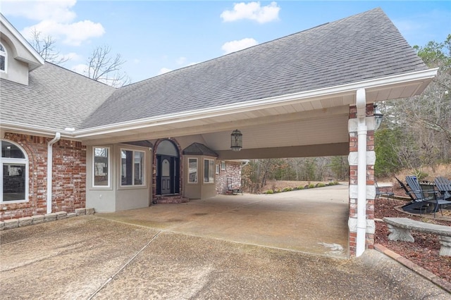 view of patio featuring an attached carport and driveway