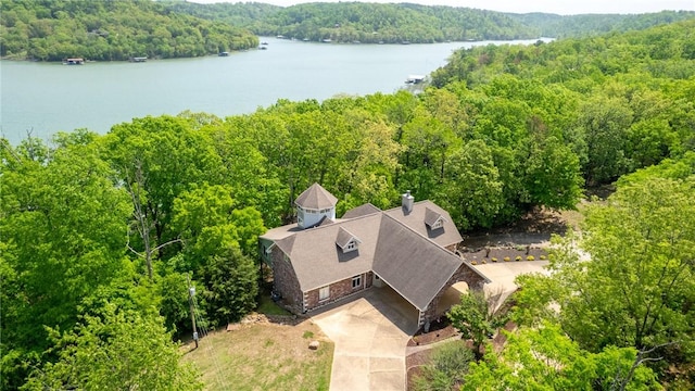 aerial view featuring a water view and a forest view