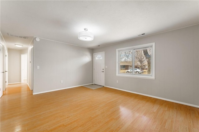 interior space with baseboards, visible vents, and light wood-style floors