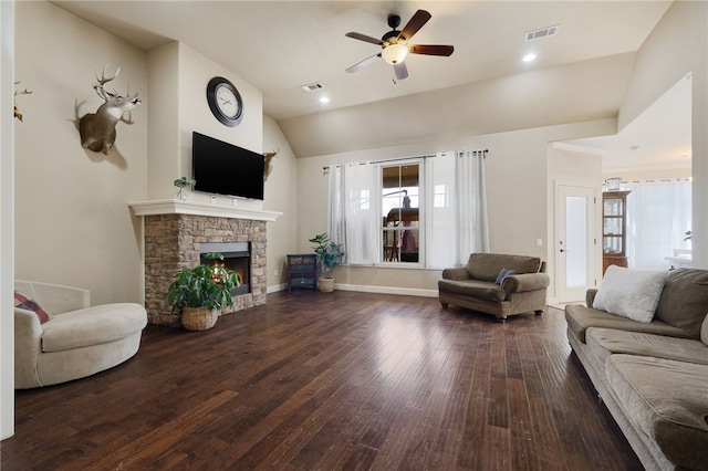 living room with vaulted ceiling, visible vents, ceiling fan, hardwood / wood-style flooring, and a fireplace