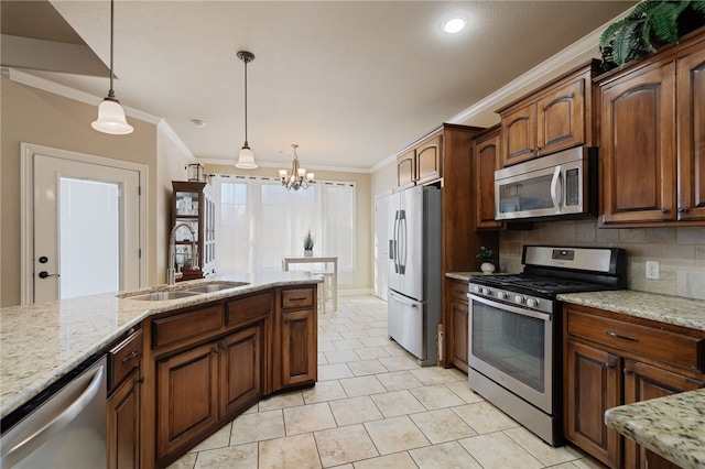 kitchen featuring an inviting chandelier, ornamental molding, a sink, and appliances with stainless steel finishes