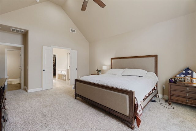 bedroom featuring light colored carpet, connected bathroom, visible vents, and high vaulted ceiling