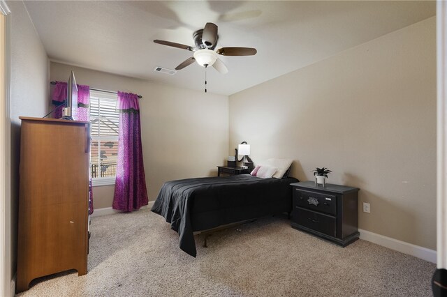 bedroom featuring visible vents, light carpet, baseboards, and ceiling fan