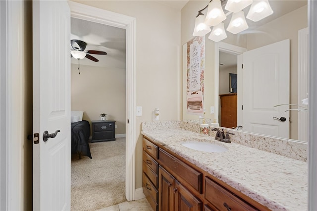 bathroom with baseboards, a ceiling fan, and vanity