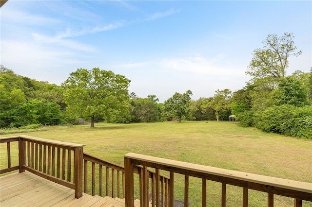 wooden terrace featuring a lawn