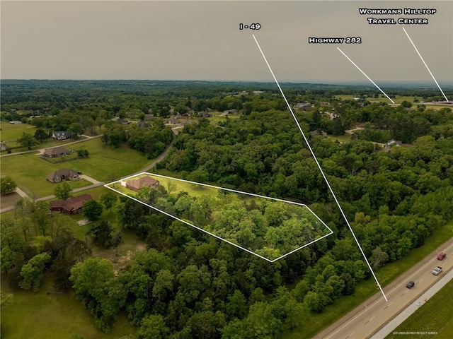 aerial view featuring a wooded view