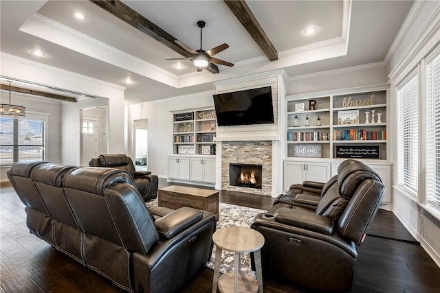 living room featuring a tray ceiling and a wealth of natural light